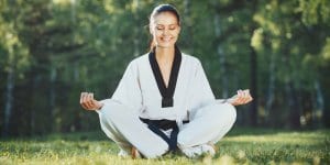 Martial Arts Lessons for Adults in Alexandria VA - Happy Woman Meditated Sitting Background